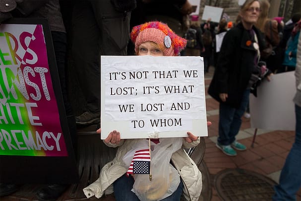Women's March, 2017, Woman with sign that reads: "It's not that we lost. It's what we lost and to whom."